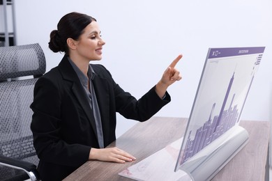Image of Building information modelling. Woman using virtual screen in office