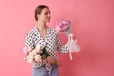 Photo of Woman with beautiful bouquets of peonies on pink background