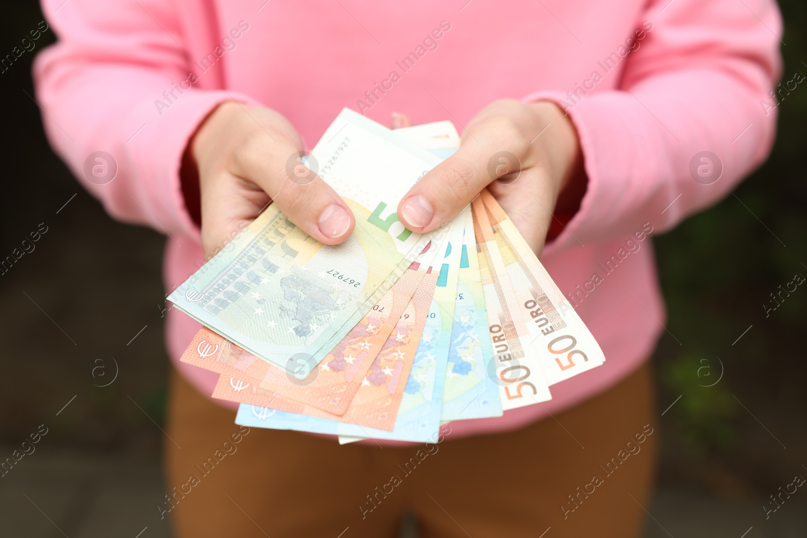 Woman counting her money outdoors, closeup view Photo of Woman counting her money outdoors, closeup view