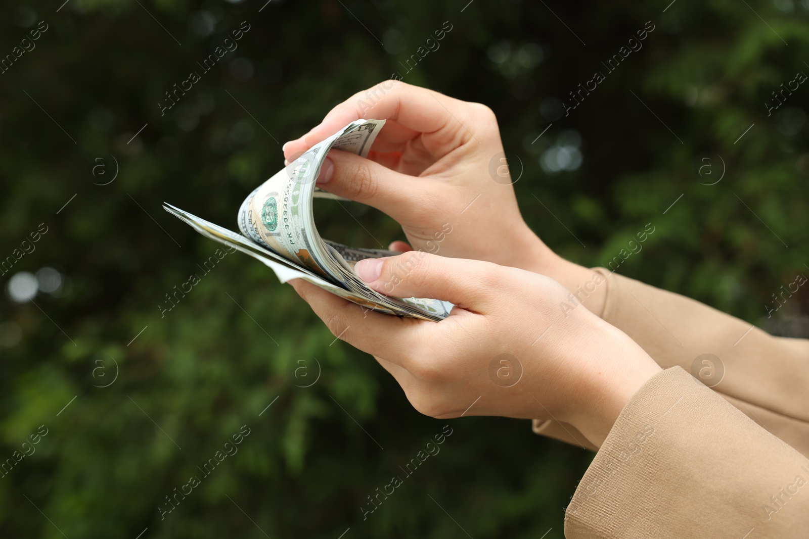 Woman counting her money outdoors, closeup view Photo of Woman counting her money outdoors, closeup view