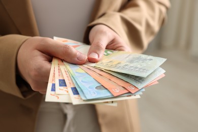 Photo of Woman counting her money indoors, closeup view