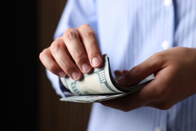 Photo of Woman counting her money indoors, closeup view
