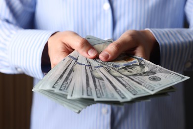 Photo of Woman counting her money indoors, closeup view