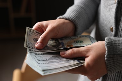 Photo of Woman counting her money indoors, closeup view
