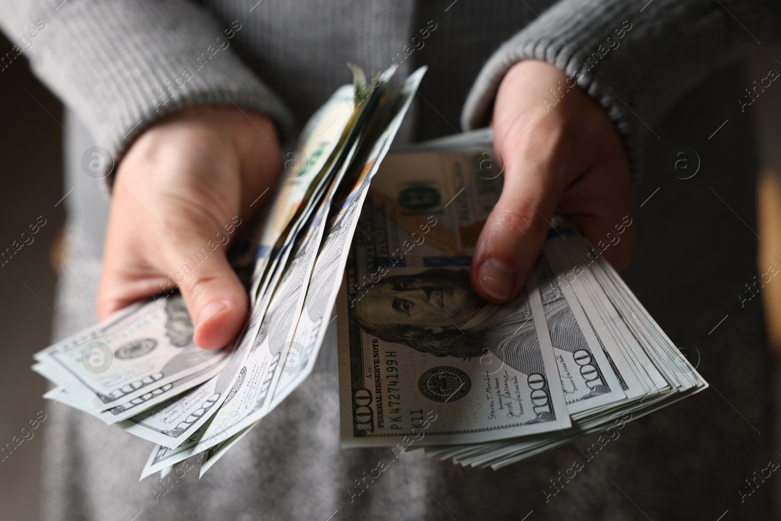 Woman counting her money indoors, closeup view Photo of Woman counting her money indoors, closeup view