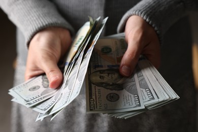 Photo of Woman counting her money indoors, closeup view
