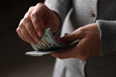 Photo of Woman counting her money indoors, closeup view
