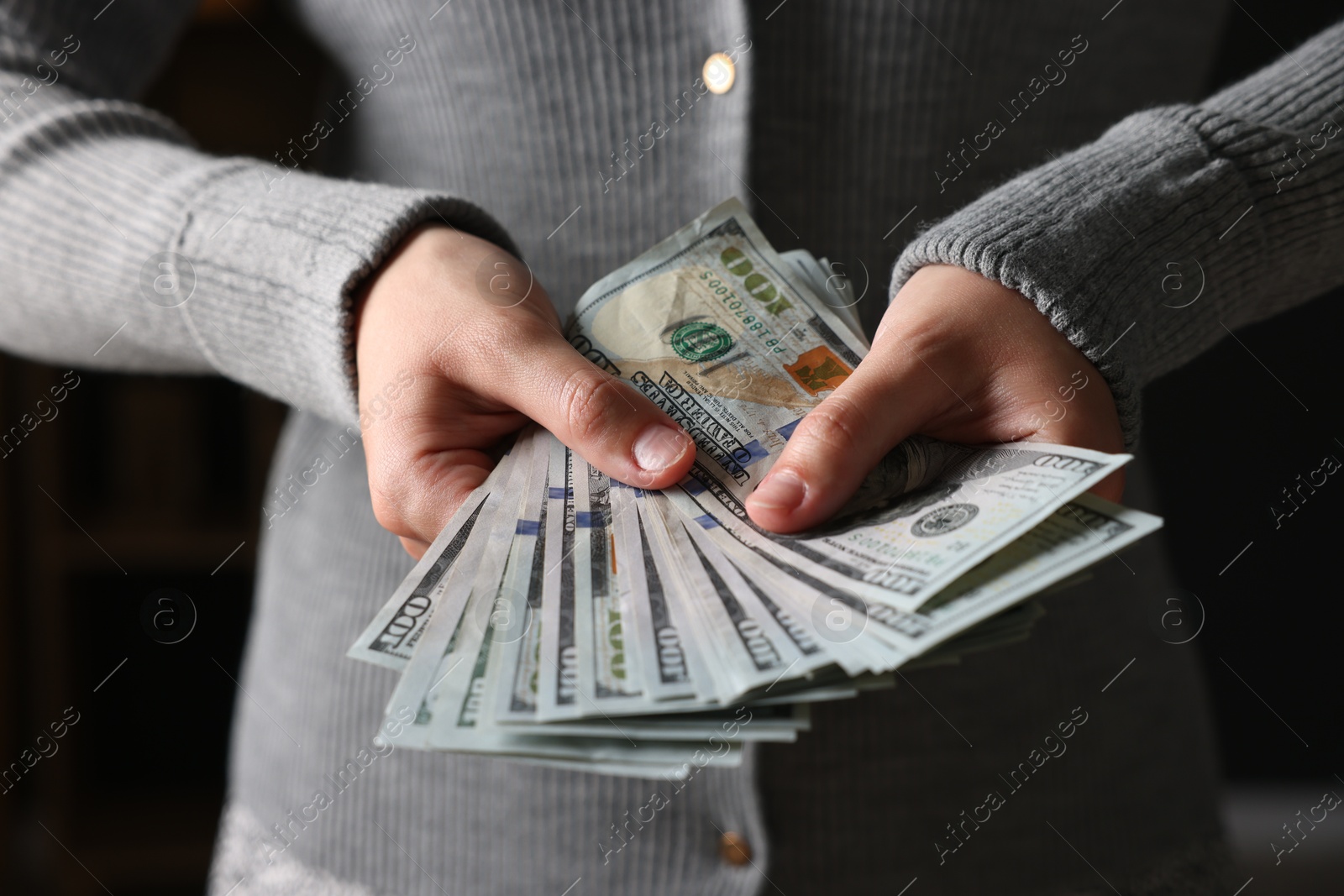 Woman counting her money indoors, closeup view Photo of Woman counting her money indoors, closeup view