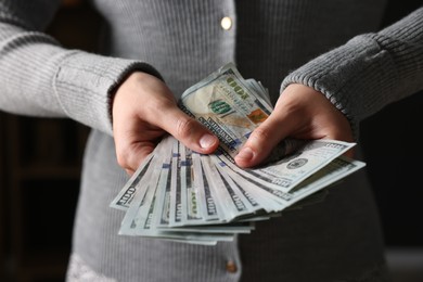 Photo of Woman counting her money indoors, closeup view