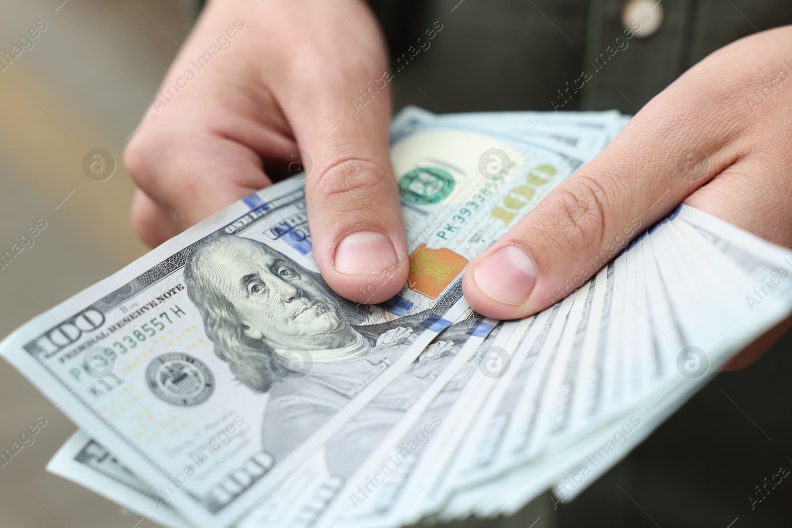 Photo of Man counting his money outdoors, closeup view