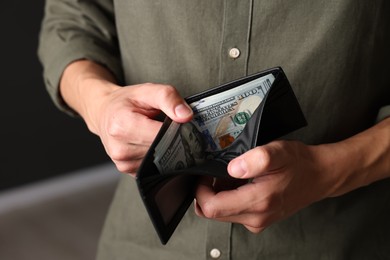 Photo of Man with money in wallet indoors, closeup
