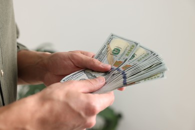 Photo of Man counting his money indoors, closeup view