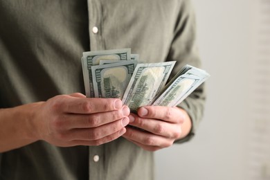 Photo of Man counting his money indoors, closeup view