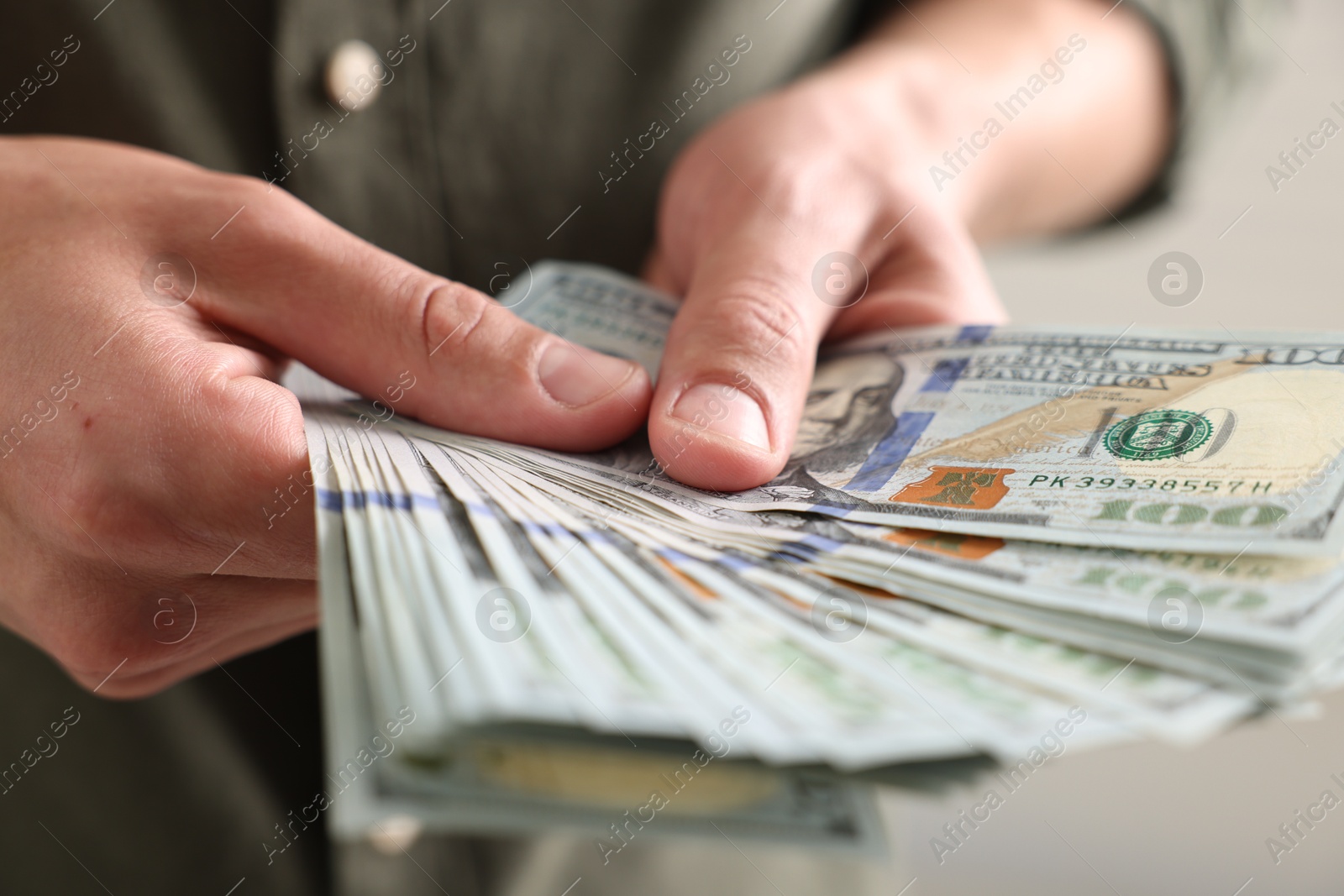 Man counting his money indoors, closeup view Photo of Man counting his money indoors, closeup view
