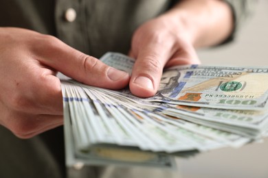 Photo of Man counting his money indoors, closeup view