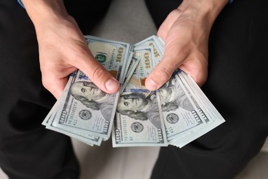 Photo of Man counting his money indoors, closeup view