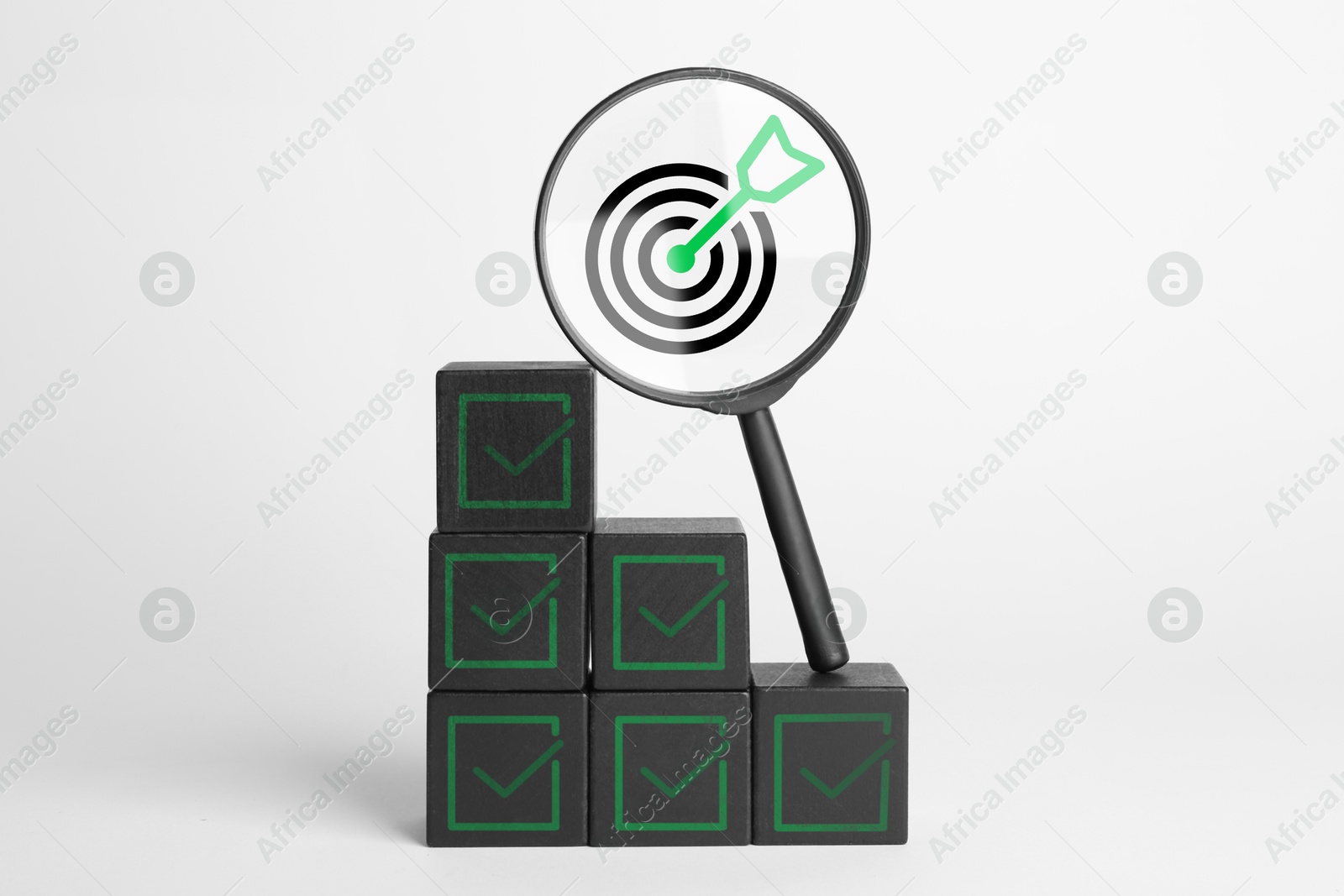 Targeting, business strategy, planning. Black cubes with check marks and magnifying glass with bullseye icon inside against white background Image of Targeting, business strategy, planning. Black cubes with check marks and magnifying glass with bullseye icon inside against white background