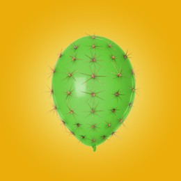 Image of Green balloon covered with cactus prickles on orange gradient background