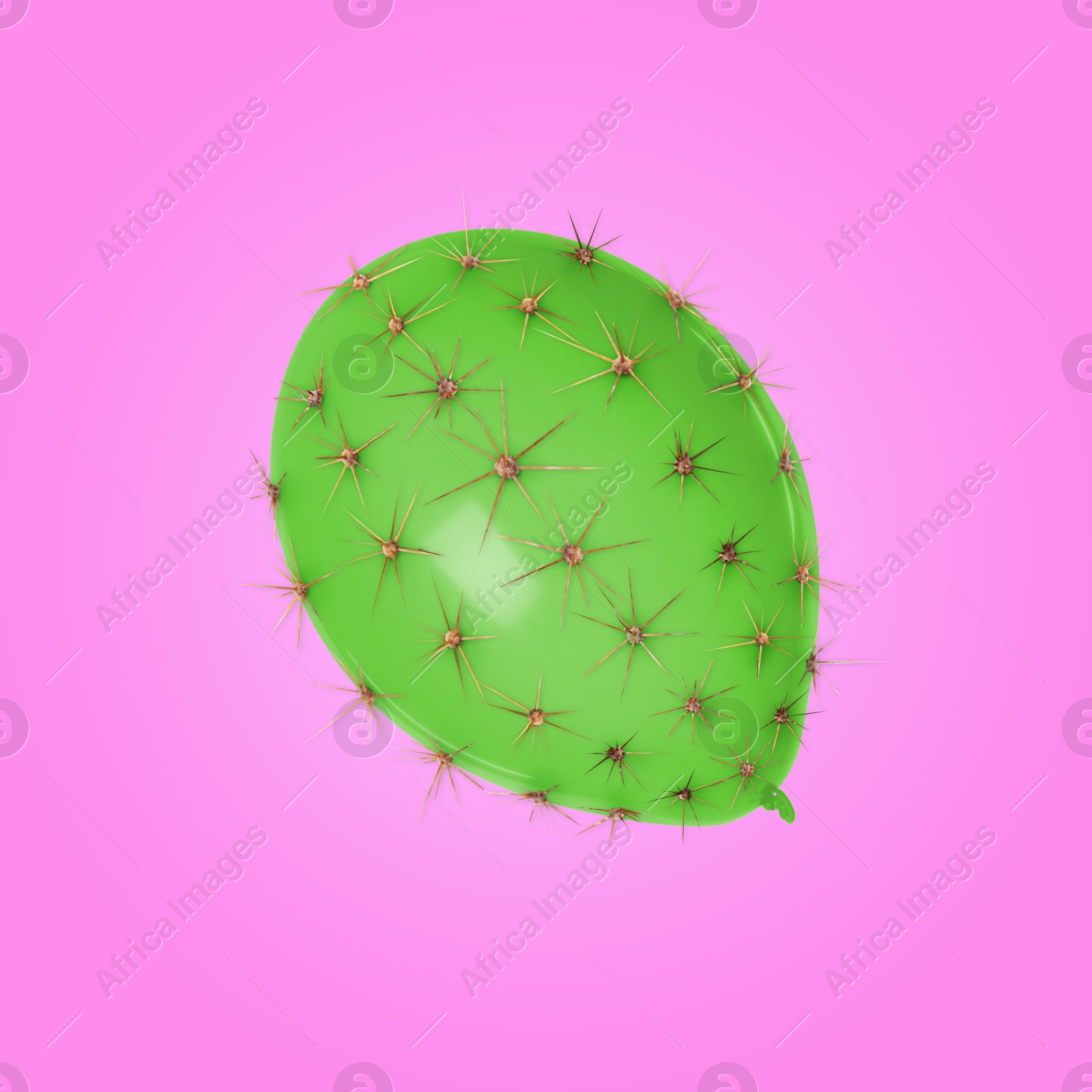 Image of Green balloon covered with cactus prickles on pink background