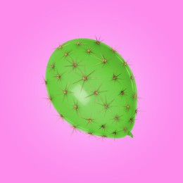 Image of Green balloon covered with cactus prickles on pink background