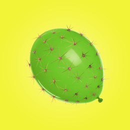 Image of Green balloon covered with cactus prickles on yellow background