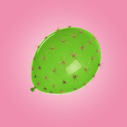 Image of Green balloon covered with cactus prickles on pink background