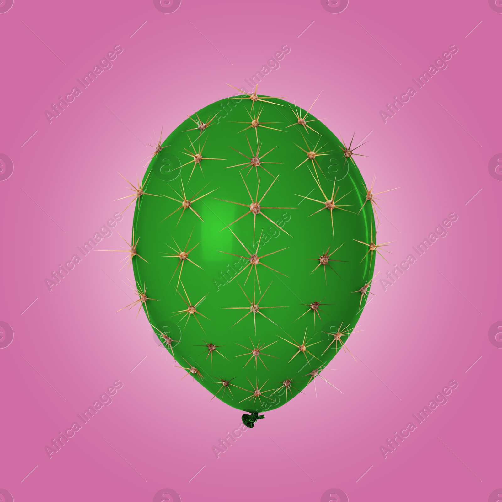 Image of Green balloon covered with cactus prickles on pink gradient background