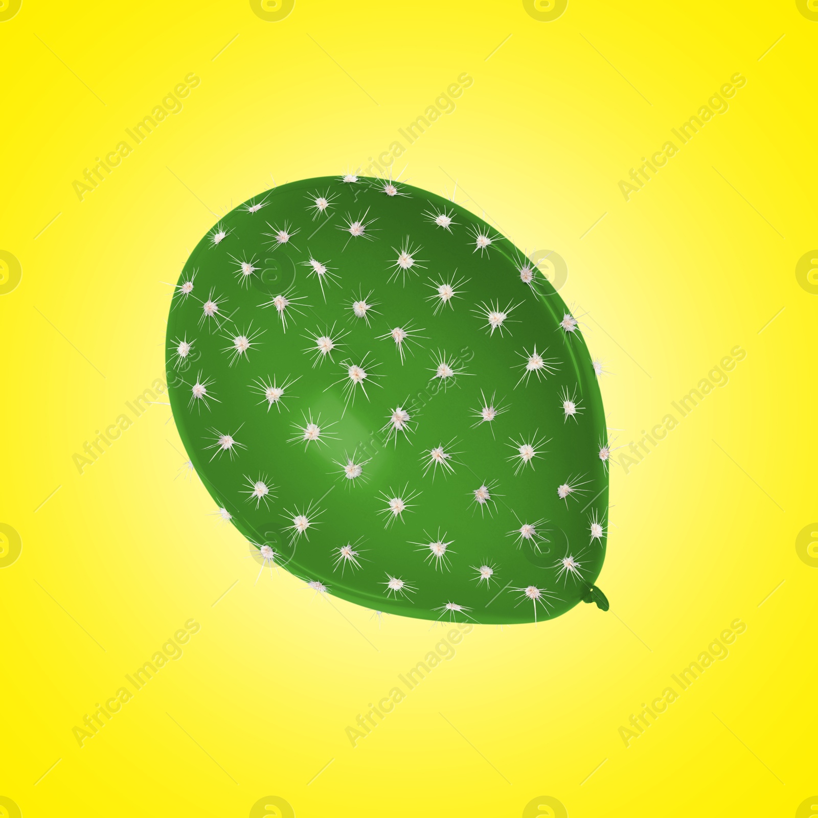 Image of Green balloon covered with cactus prickles on yellow gradient background