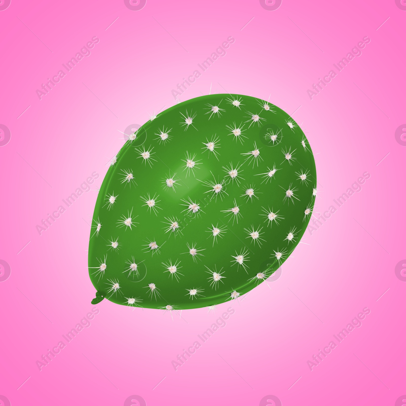 Image of Green balloon covered with cactus prickles on pink gradient background