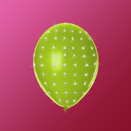 Image of Green balloon covered with cactus prickles on crimson gradient background
