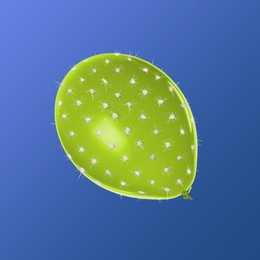 Image of Green balloon covered with cactus prickles on blue background