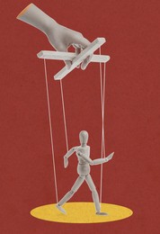 Image of Woman's hand pulling strings of puppet on dark red background. Creative artwork