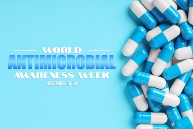 Image of World antibiotic awareness week. Many pills on light blue background, flat lay