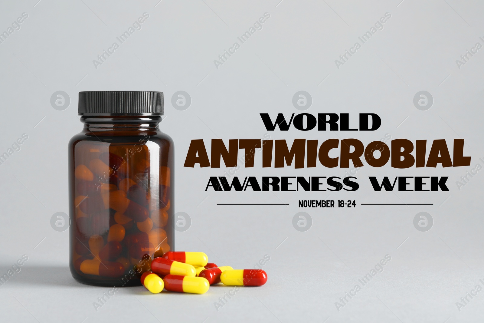 World antibiotic awareness week. Bottle and scattered pills on grey background Image of World antibiotic awareness week. Bottle and scattered pills on grey background