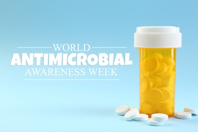 Image of World antibiotic awareness week. Bottle and scattered pills on light blue background