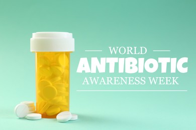 Image of World antibiotic awareness week. Bottle and scattered pills on turquoise background