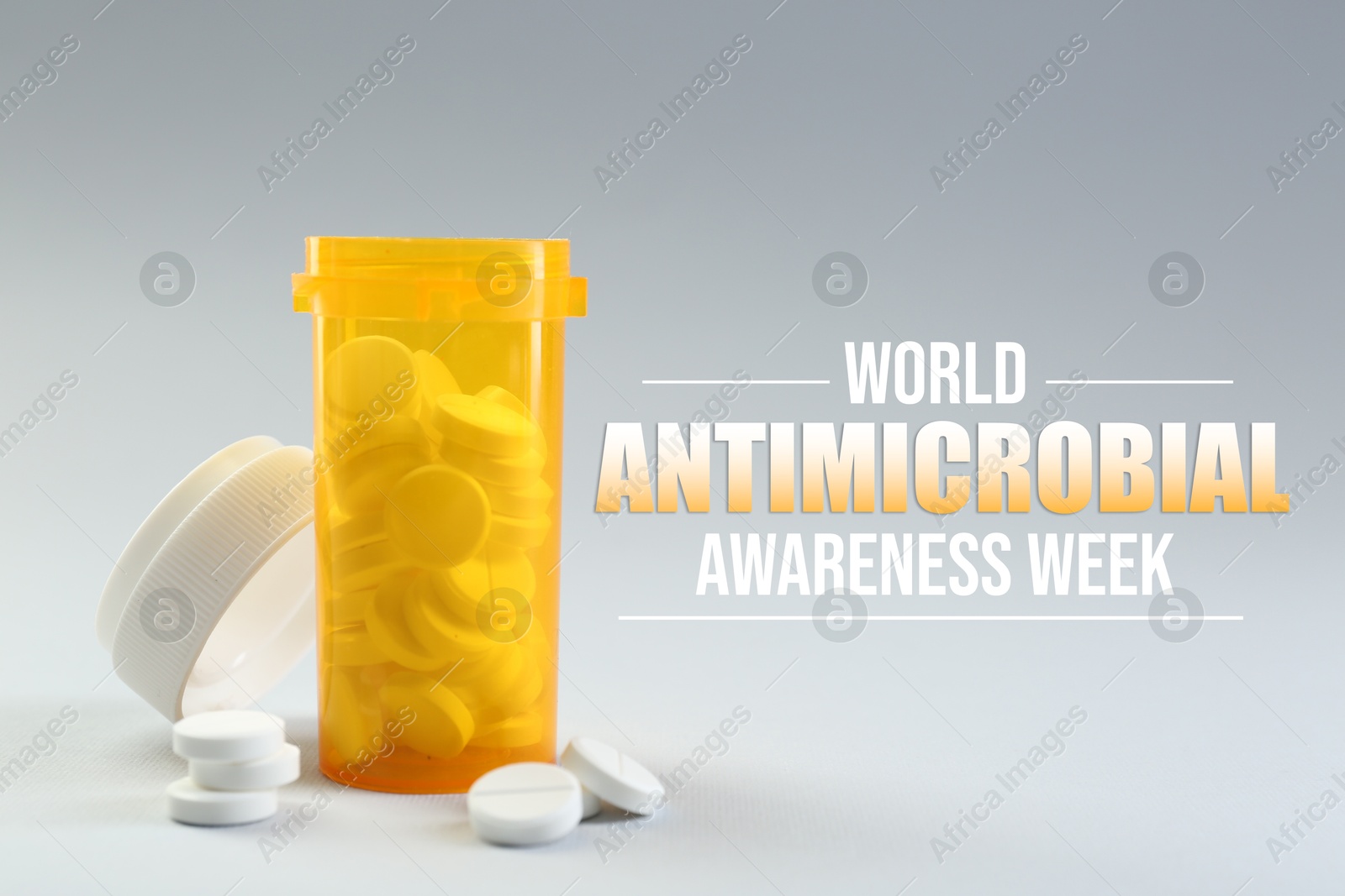World antibiotic awareness week. Bottle and scattered pills on grey background Image of World antibiotic awareness week. Bottle and scattered pills on grey background