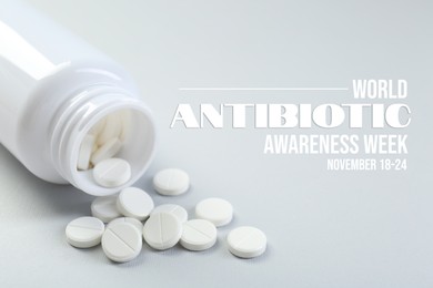 Image of World antibiotic awareness week. Bottle and scattered pills on light background