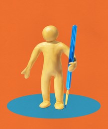 Image of Yellow plasticine human figure with paintbrush on blue circle against orange background