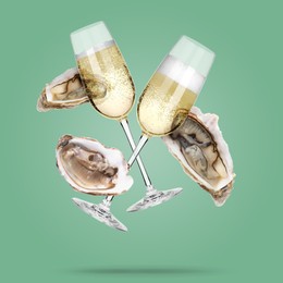 Image of Sparkling wine in glasses and fresh oysters falling on aquamarine color background