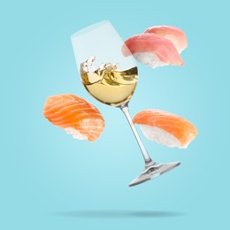 Image of White wine in glass and nigiri sushi falling on light blue background