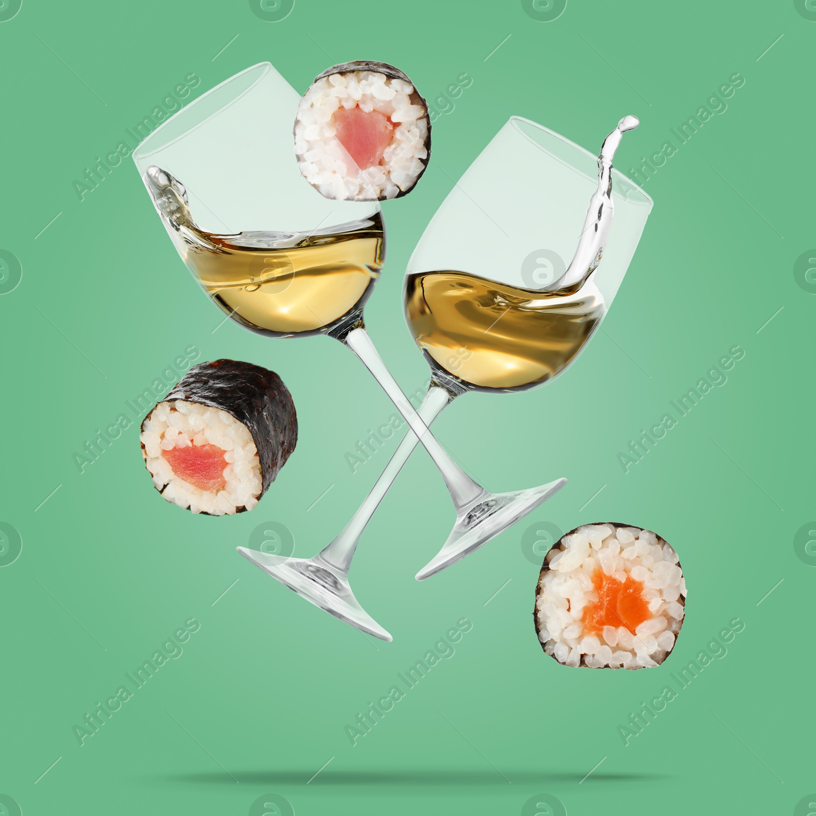 Image of White wine in glasses and sushi rolls falling on aquamarine color background