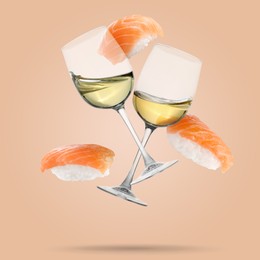 Image of White wine in glasses and nigiri sushi falling on beige background