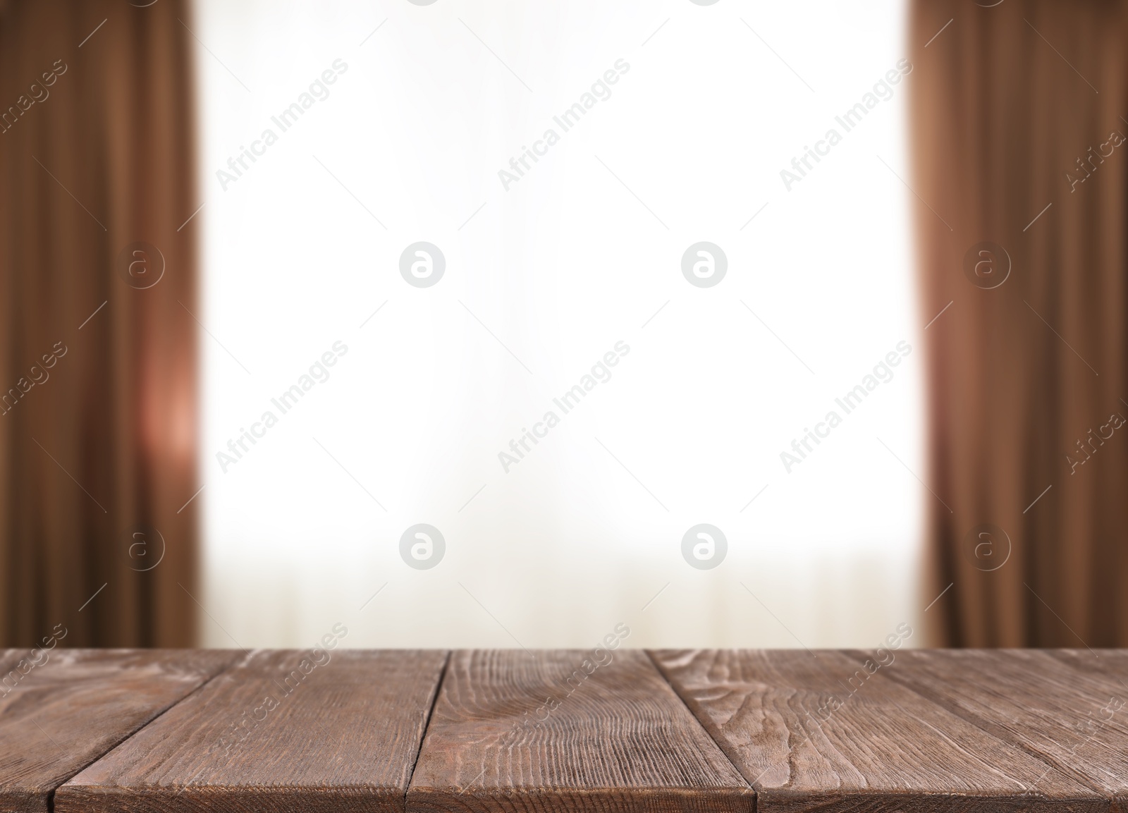 Image of Empty wooden table against window with curtains in room