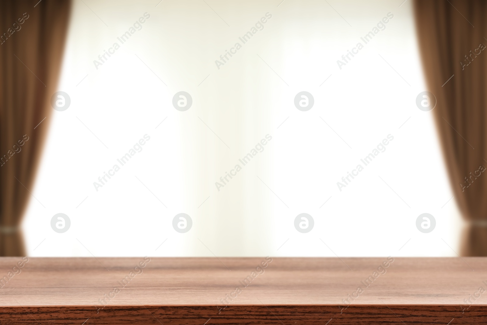 Image of Empty wooden table against window with curtains in room