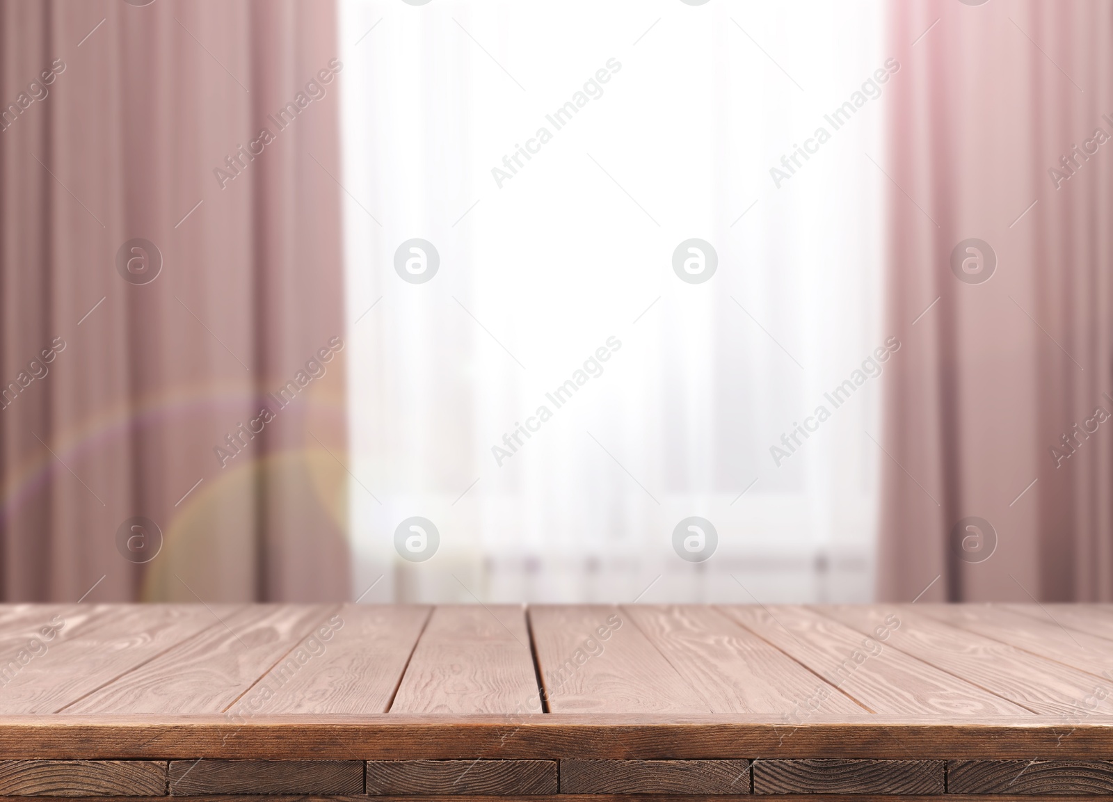 Empty wooden table against window with curtains in room Image of Empty wooden table against window with curtains in room