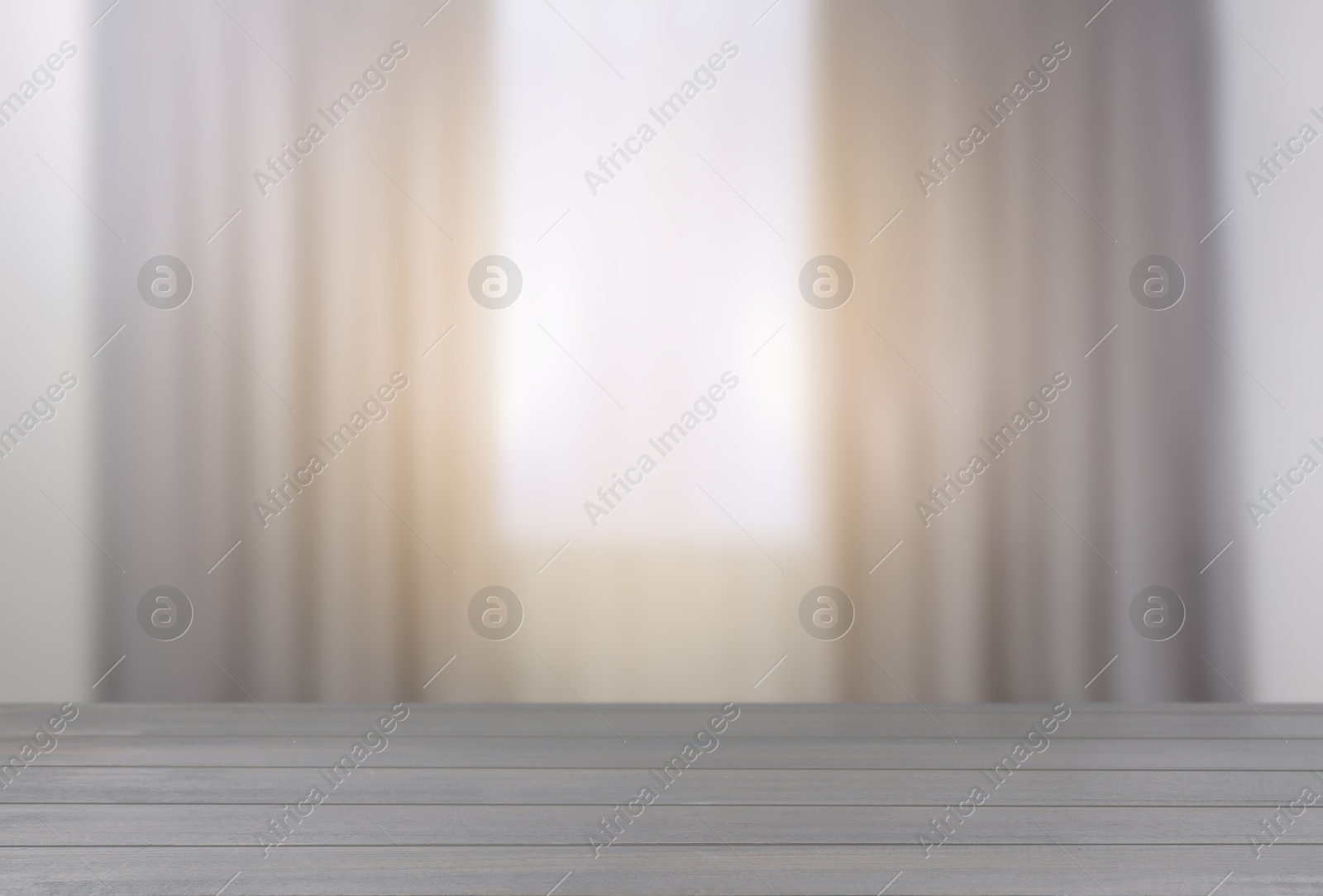 Image of Empty wooden table against window with curtains in room