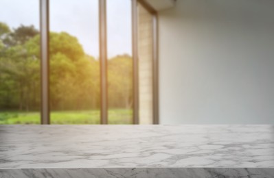 Image of Empty marble table against window in room