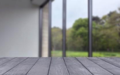 Image of Empty wooden table against window in room