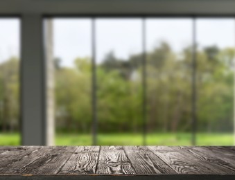 Image of Empty wooden table against window in room
